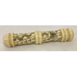 A carved bone Scrimshaw style screw top needle case with carved Royal Crest.