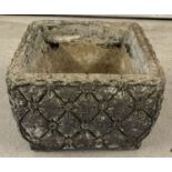 A concrete square shaped Daisy Chain Series garden planter with quilted and daisy detail.