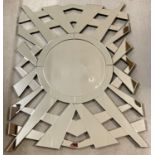 A large modern sunburst design wall hanging mirror with bevel edged glass.