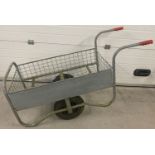 A vintage galvanised metal wheelbarrow/trolley with large rubber tyres.