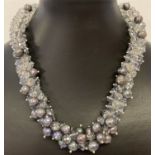 A 16" chunky statement necklace made from freshwater peacock pearls and faceted crystal beads.
