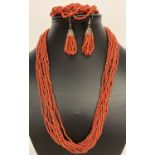 A matching multistrand coral chip necklace, bracelet and drop earring set.