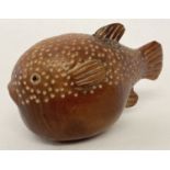 A small Japanese carved fruitwood snuff pot in the form of a blowfish.