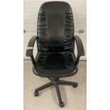 A modern style faux leather office chair with black plastic arms & adjustable height.
