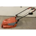 An electric Flymo Hover Compact 300 lawnmower.