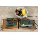 A Bosch PSS230 Orbital Sander together with a Bosch PST52A Jigsaw and a tub of sandpaper.