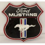 A Ford Mustang painted cast iron wall plaque, with fixing holes.