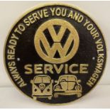 A painted cast metal circular shaped VW Service plaque.