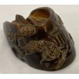 A carved hoof with Chinese figural and cherry blossom design.