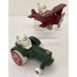 2 painted cast iron figures of Michelin men driving vehicles, with moving wheels.