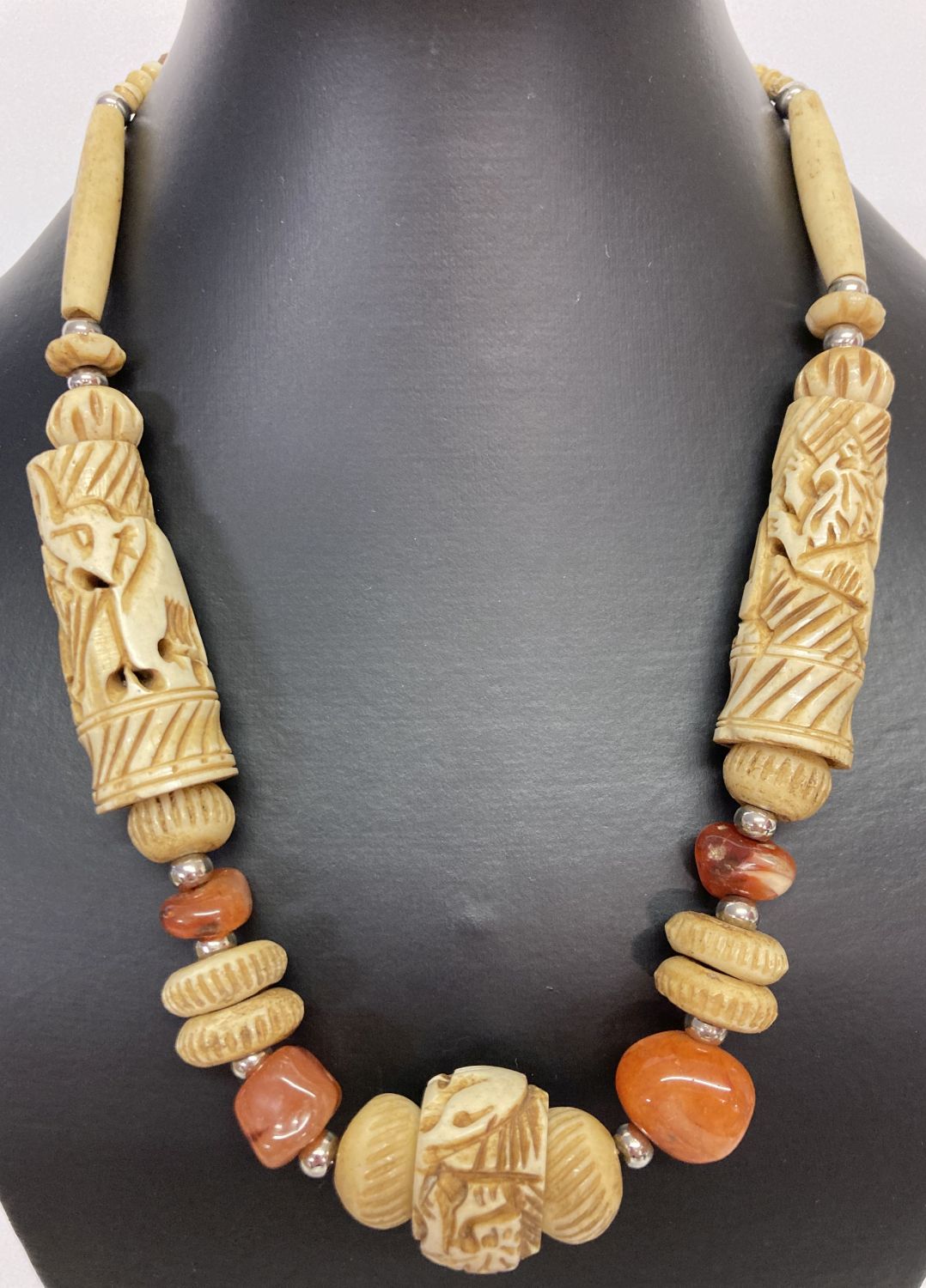 A carved bone and natural agate statement necklace with screw barrel clasp.