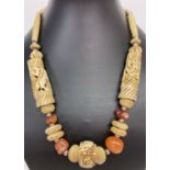 A carved bone and natural agate statement necklace with screw barrel clasp.