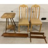 2 modern dinning chairs together with a vintage occasional table with 2 wall hanging shelves.