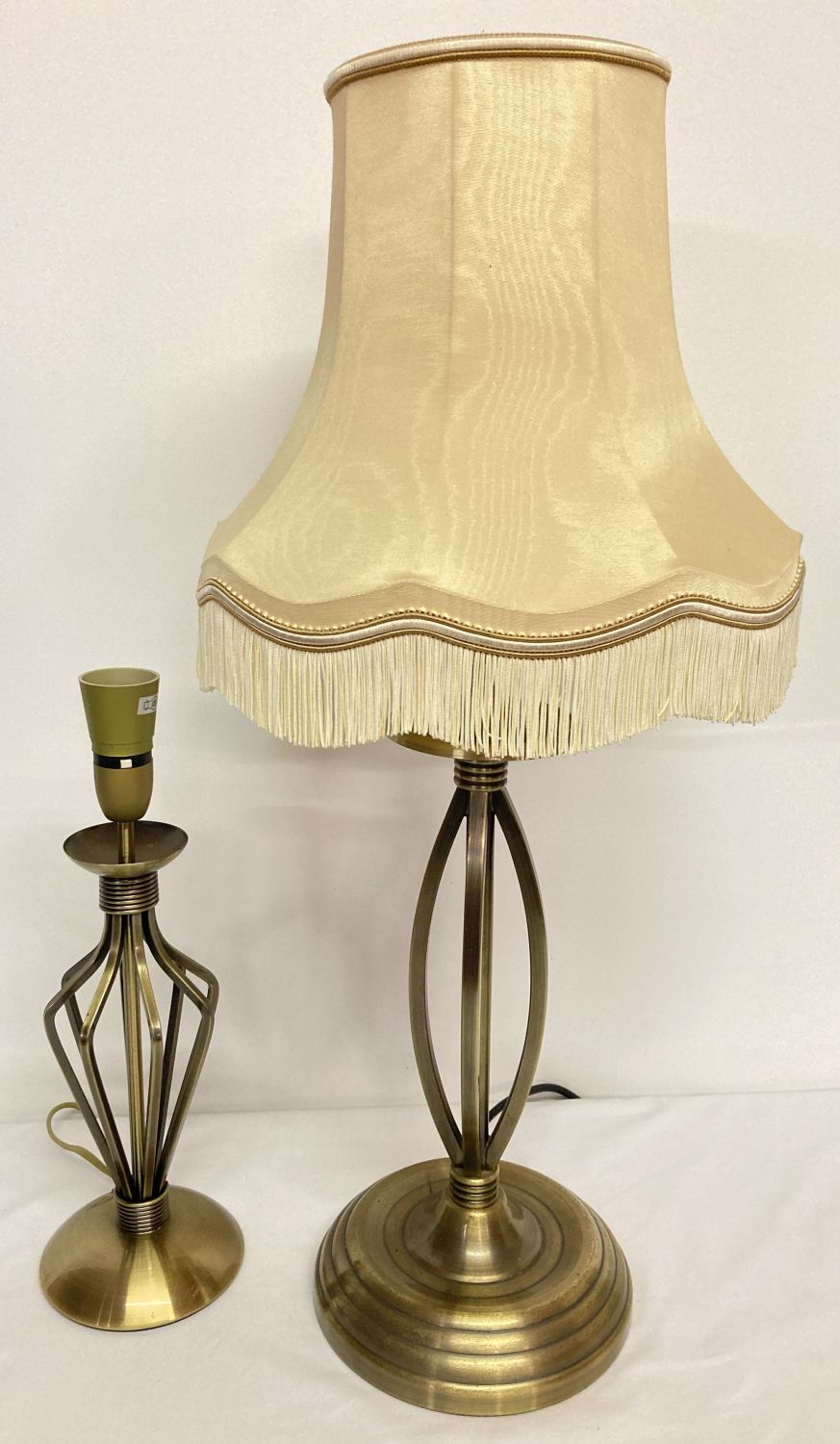 2 modern brushed bronze effect metal table lamps, together with a cream lamp shade.