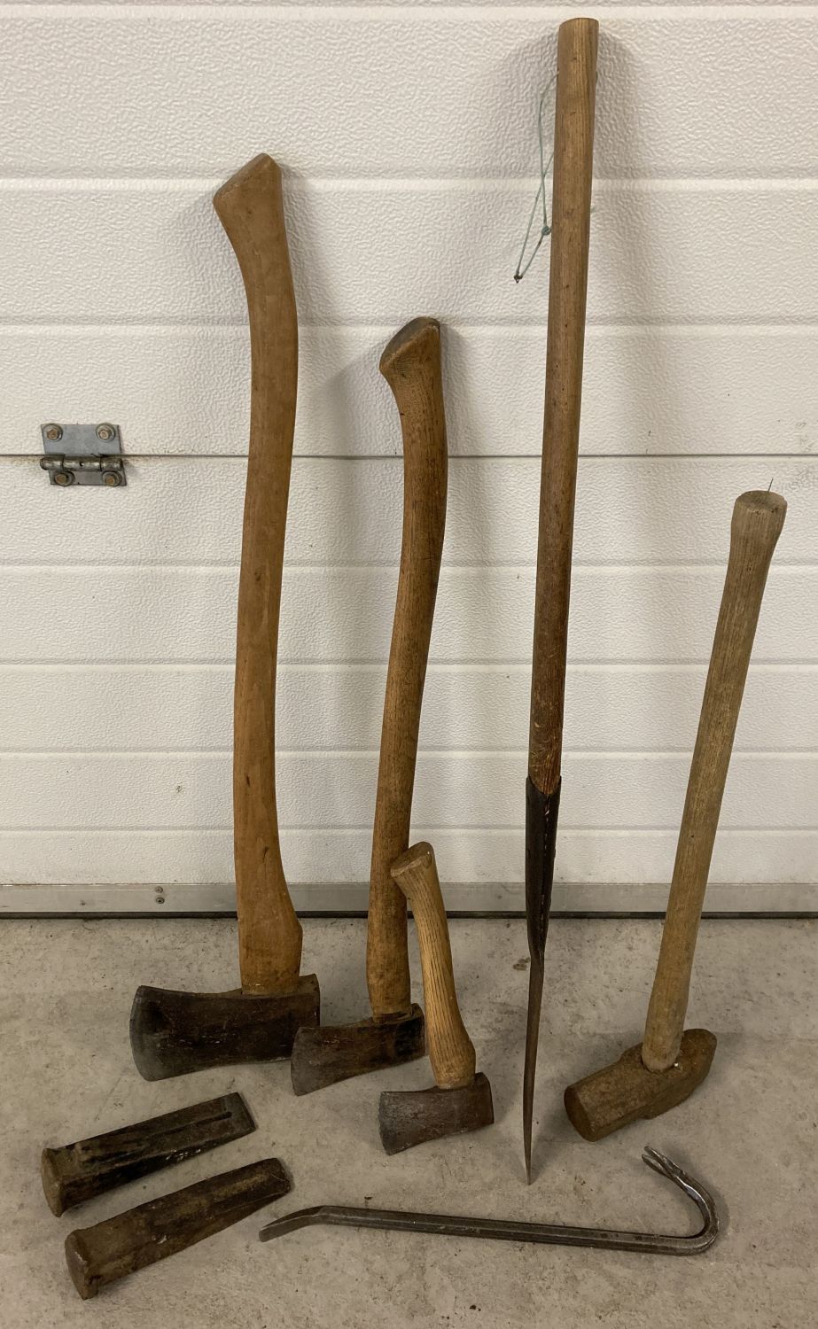 A small collection of mostly wooden handled tools.