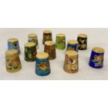 A collection of 12 assorted enamelled thimbles with floral detail.