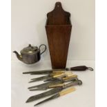 A vintage wooden wall hanging candle box with cutlery and a silver plated teapot.