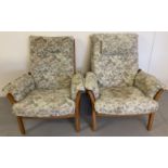 2 Ercol light wood framed, slat backed armchairs with floral & hummingbird design upholstery.
