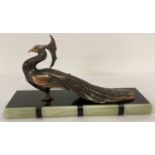 An Art Deco marble and onyx based spelter figurine of a peacock.