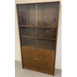 A vintage 1960's dark teak glass fronted bookcase by Herbert E Gibbs.