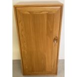 A vintage light elm Ercol Windsor single door cupboard with 2 adjustable interior shelves.