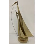 A mid 20th century brass sail boat sculpture by John & Don DeMott with flag and seagull detail.