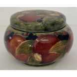 An early 20th century William Moorcroft tobacco jar in Pomegranate design, with screw top cover.