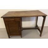 A vintage 1940's dark oak framed Utility desk with single drawer and cupboard.