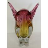A large, heavy Art glass vase in pink and amber tones with clear glass base.