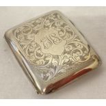 A vintage silver floral engraved cigarette case with gilt interior.