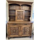 An Antique highly carved medium oak double dresser, possibly French or Dutch.