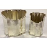 2 matching silver plated pen holders with shaped rims and engraved detail to fronts.