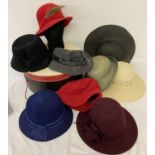 A modern large hat box together with a collection of vintage and modern felt and straw hats.