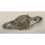 An Art Nouveau style white metal brooch.