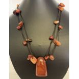 A modern design cord and carnelian necklace.
