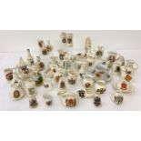 A collection of assorted crested ware ceramic trinkets to include novelty shaped pieces.