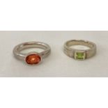 2 silver rings. A modern design silver dress ring by Monet set with an oval cut orange spinel stone.