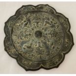 A large Chinese Tang Dynasty style mirror with ornately decorated reverse of floral and bird design.