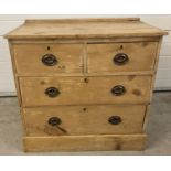 A vintage rustic pine 2 over 2 chest of drawers with metal drop down handles.