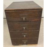 A vintage dark oak 4 drawer card index filing cabinet with brass handles.