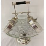 A cut glass and silver plated double ended biscuit barrel raised on a pedestal foot.