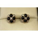 A pair of 9ct gold black onyx and diamond stud earrings by Luke Stockley, London.