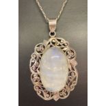 A large ornate moonstone pendant on a 20" fine belcher chain.