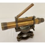 A small brass cased swivel telescope with integral compass and spirit level.