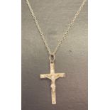 A silver crucifix pendant on a 18 inch silver fine curb chain.