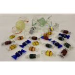 A collection of multi coloured glass sweets in varying shapes and sizes.
