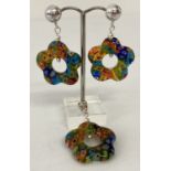 A glass flower shaped millefiori style pendant and matching earrings.