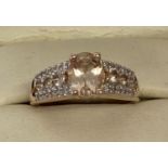A boxed rose gold plated silver dress ring set with morganite and clear stones, by Danbury Mint.