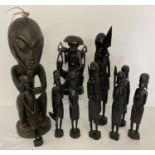 A collection of 10 carved wooden tribal and oriental figures in varying sizes.