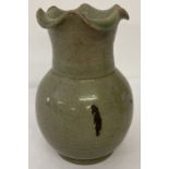 A Chinese celadon glaze vase with scalloped rim and crackle glaze.
